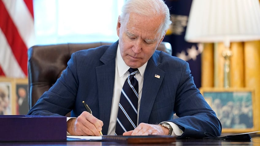 President Joe Biden signs the American Rescue Plan