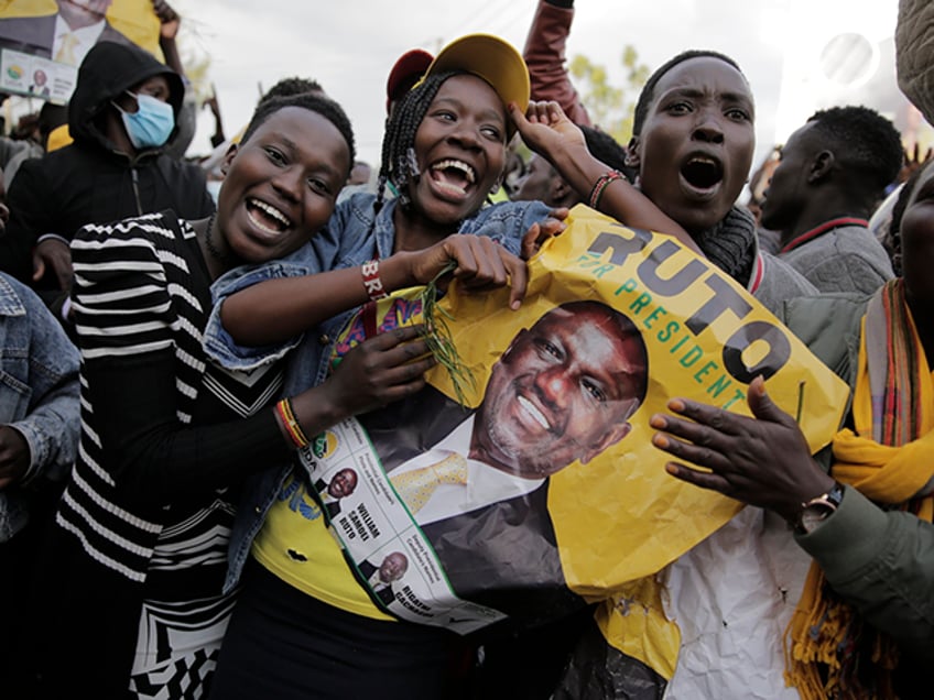 Supporters of Deputy President and presidential candidate William Ruto celebrate his victory over opposition leader Raila Odinga in Eldoret, Kenya, Monday, Aug. 15, 2022. Ruto received 50.49% of the vote, the chairman of the electoral commission said, while Odinga received 48.85%. (AP Photo/Brian Inganga)