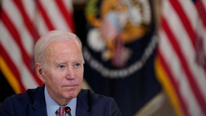 President Joe Biden listens to a reporters question