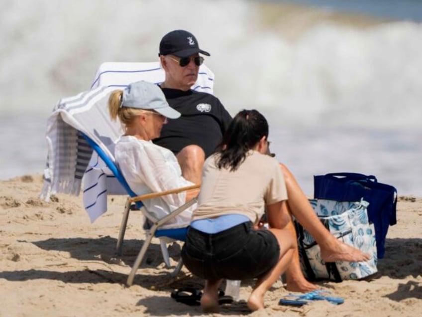 President Joe Biden and first lady Jill Biden, left, sit at the beach in Rehoboth Beach, D