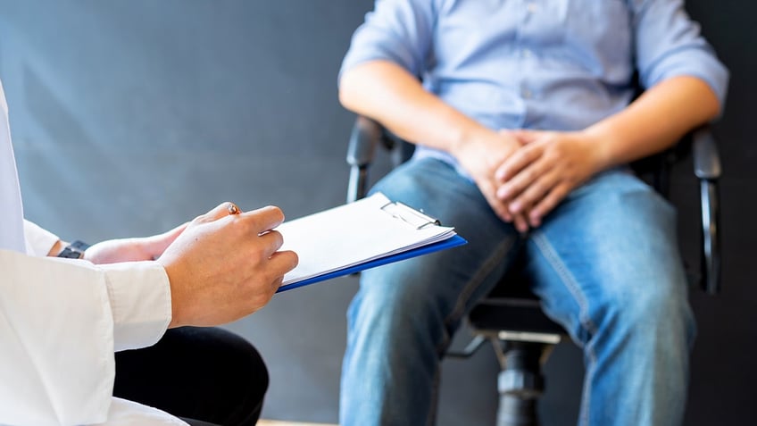 man at doctor's appointment stock image