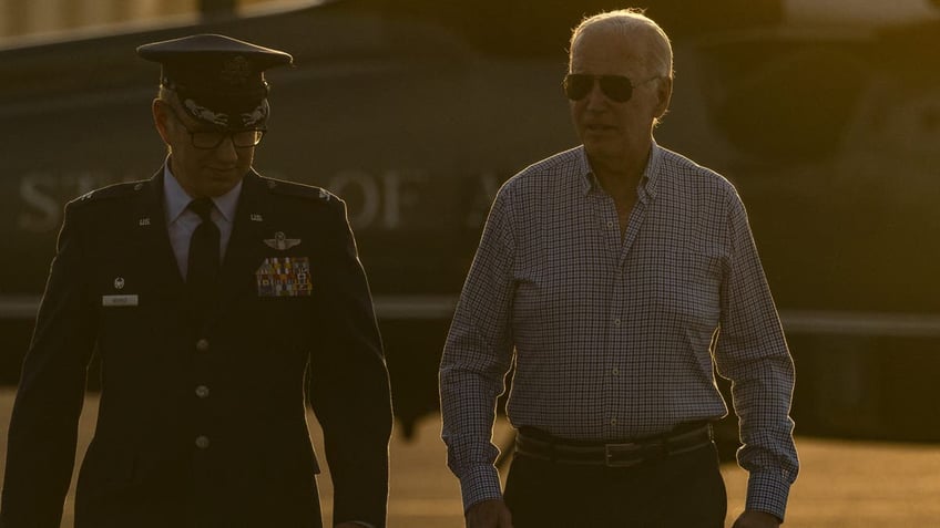 United States Air Force airmen on the left, President Joe Biden on the right