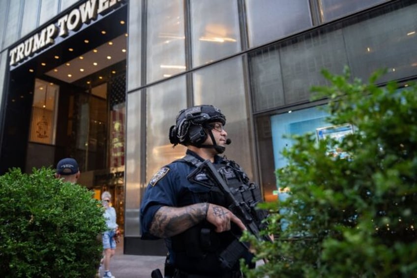 Law enforcement stand guard outside of Trump Tower in New York City after the rally shooti