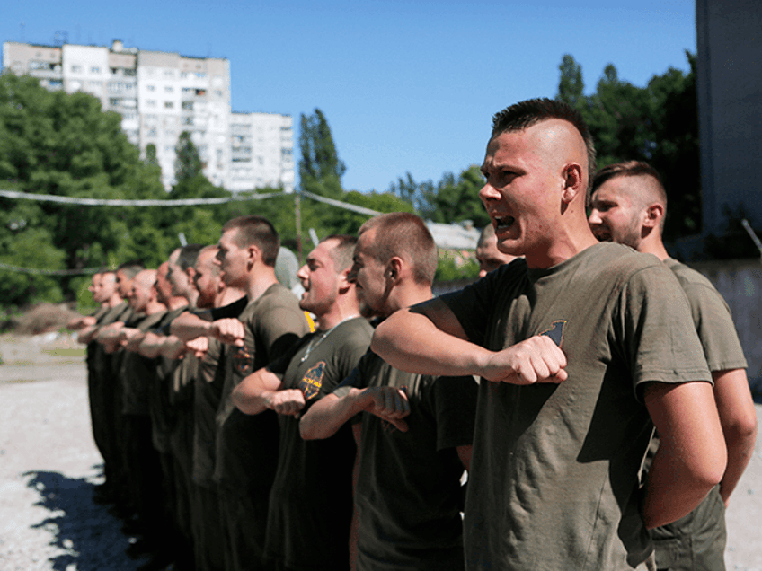 Volunteers from the Azov volunteer battalion read a prayer after a training session in Kiev, Ukrain