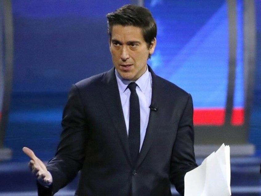 ABC World News Tonight Anchor David Muir, left, addresses members of the audience while st