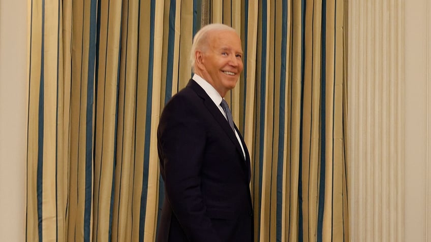 President Biden grins as he is asked questions about Trump's conviction