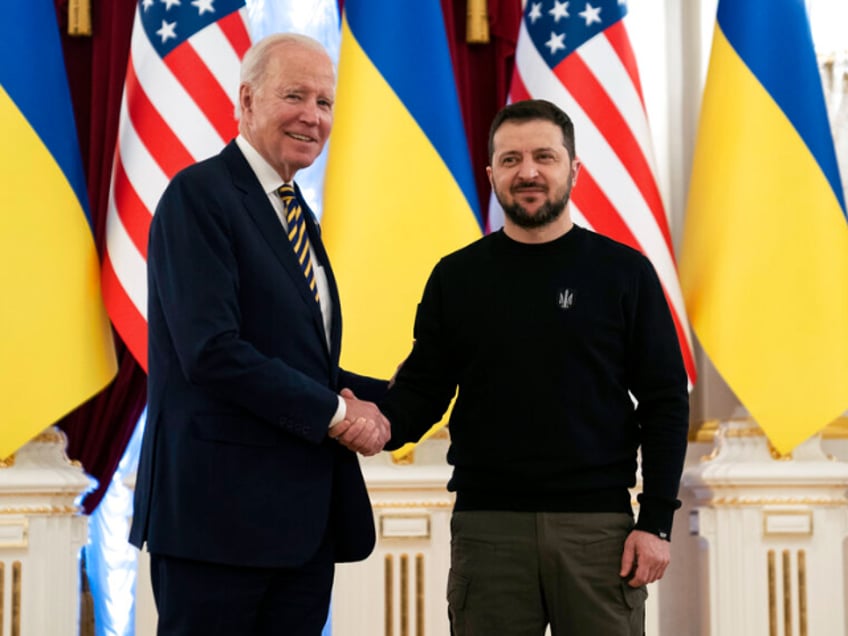 US President Joe Biden, left, shakes hands with Ukrainian President Volodymyr Zelenskyy at Mariinsky Palace during an unannounced visit in Kyiv, Ukraine, Monday, Feb. 20, 2023. (AP Photo/Evan Vucci, Pool)