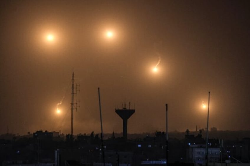 A view from Rafah shows flares fired by Israeli soldiers over Khan Yunis in southern Gaza on December 22, 2023