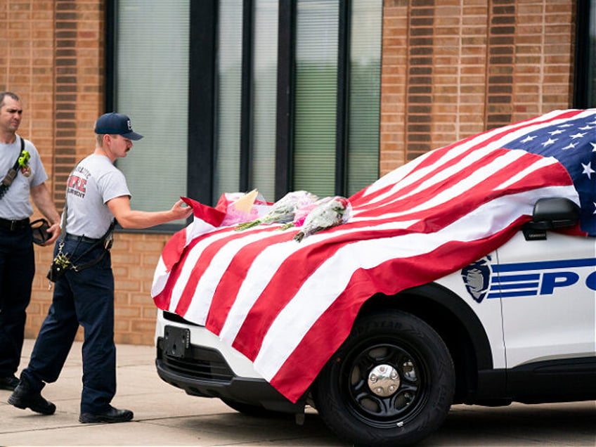 CHARLOTTE, NORTH CAROLINA - APRIL 30: Charlotte firefighters visit a memorial at the Charl