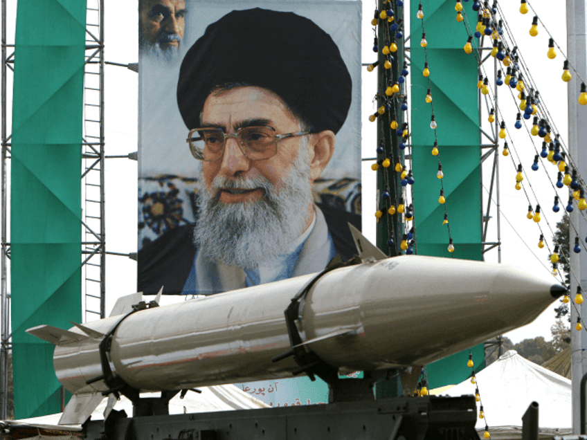 An unidentified Iranian missile stands on display in front of a large portrait of Iran's Supreme Leader Ayatollah Ali Khamenei in a square in south Tehran on September 28, 2008 (ATTA KENARE/AFP/Getty Images).