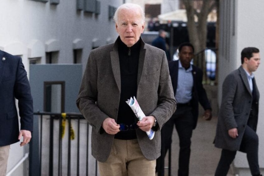 US President Joe Biden approaches the media after leaving St Edmond Roman Catholic Church