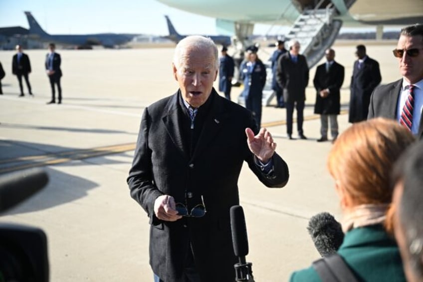 US President Joe Biden speaks to members of the media upon arrival at Milwaukee Mitchell International Airport in Milwaukee, Wisconsin