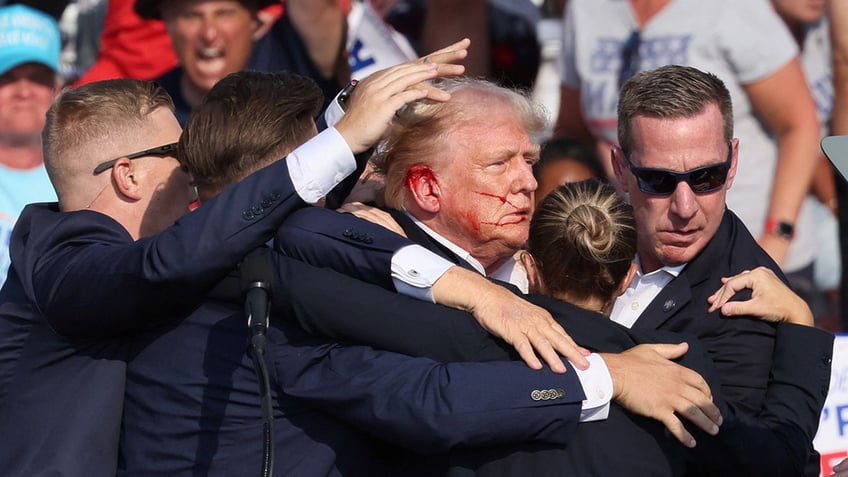 Donald Trump with bloodied face at rally