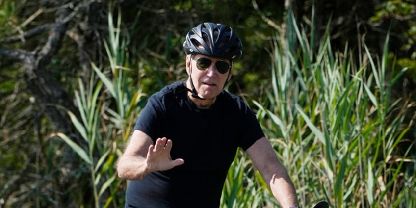 biden takes leisurely bike ride at delaware vacation home as hunter biden scandal surges