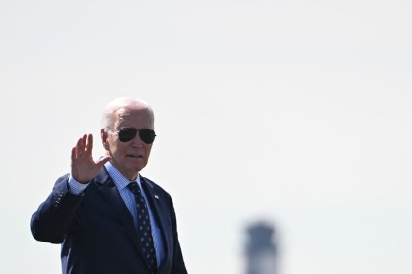 US President Joe Biden waves as he walks to board Air Force One at Philadelphia Internatio