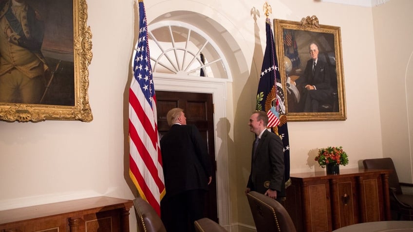 Former Special Assistant to the President and Deputy Director of National Intelligence for Strategy & Communications Cliff Sims and President Donald Trump share a laugh in the Cabinet Room of the White House. (Official White House Photo By Shealah Craighead) 