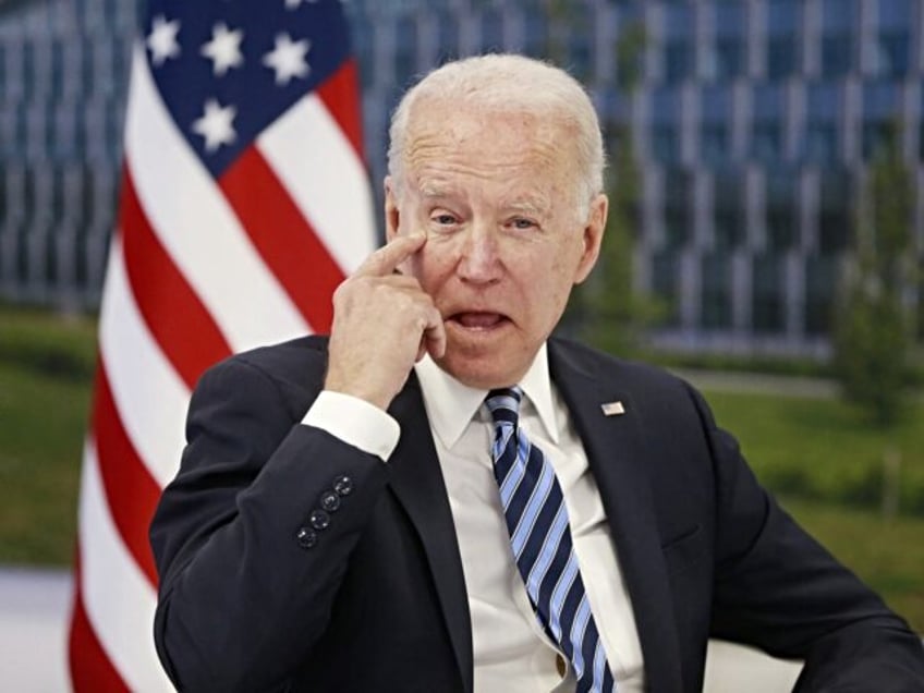 US President Joe Biden scratches his eye as he meets with NATO Secretary General during a