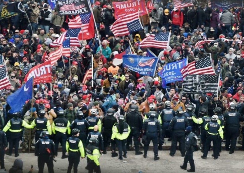 Trump supporters clash with police and security forces as they storm the US Capitol in Washington, DC on January 6, 2021