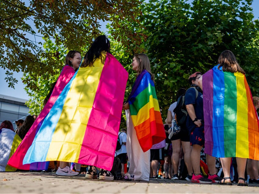 07 September 2024, Thuringia, Erfurt: Christopher Street Day (CSD) participants with rainb