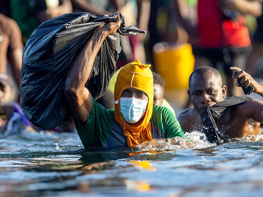 Haitian immigrants cross the Rio Grande back into Mexico from Del Rio, Texas on September