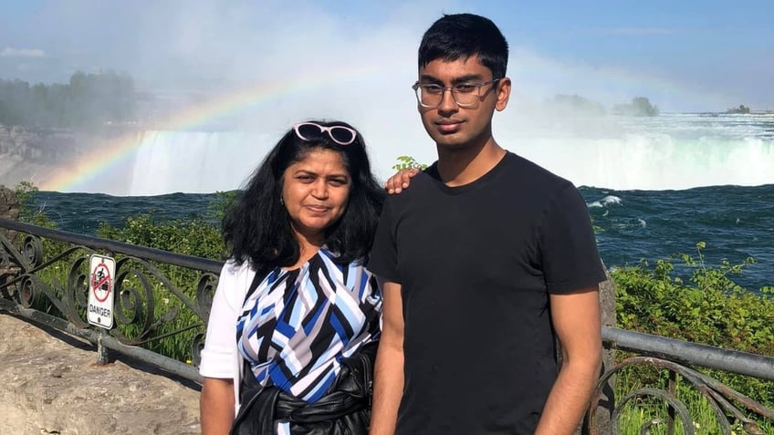 Suchir Balaji poses with his mother