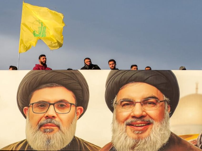 A giant portait of slain Hezbollah leader Hassan Nasrallah (R) and his heir apparent Hashe