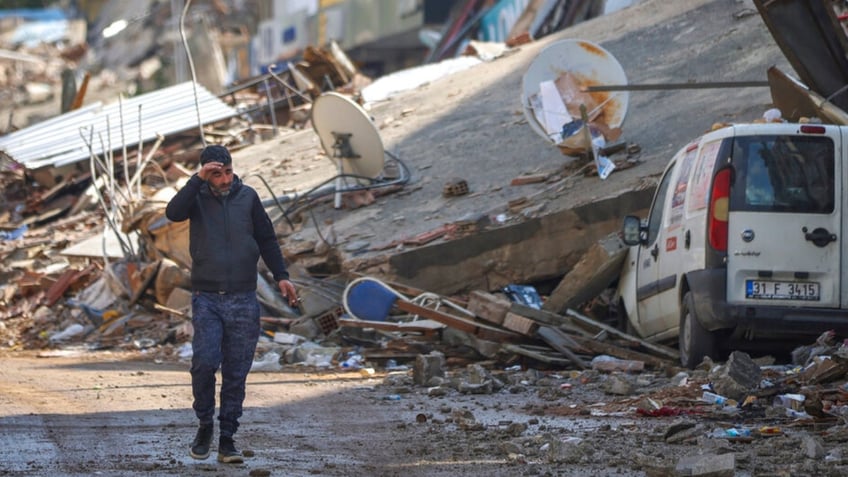 A man walks past debris in Turkey