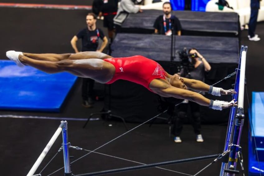 Simone Biles trains on the uneven bars ahead of the US Olympic gymnastics trials