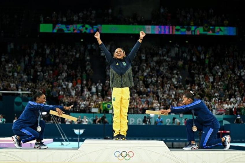 US gymnastics great Simone Biles (L) and teammate Jordan Chiles (R) bow to Brazil's Rebeca