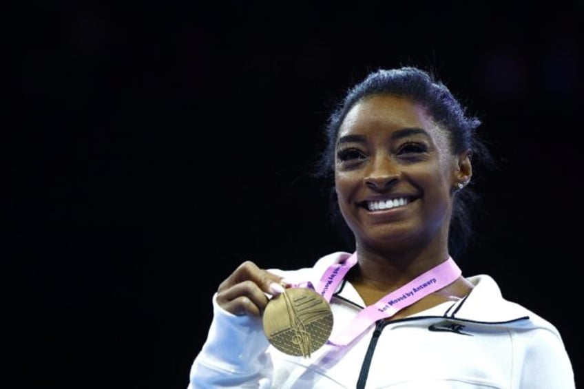 biles dazzles with beam and floor golds to reach 23 world titles