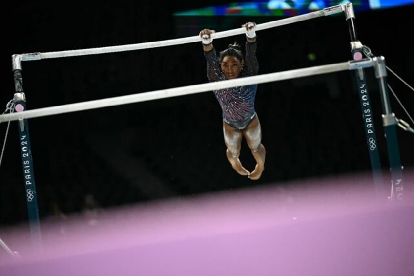 Four-time Olympic gold medallist Simone Biles trains on uneven bars in the run-up to the P