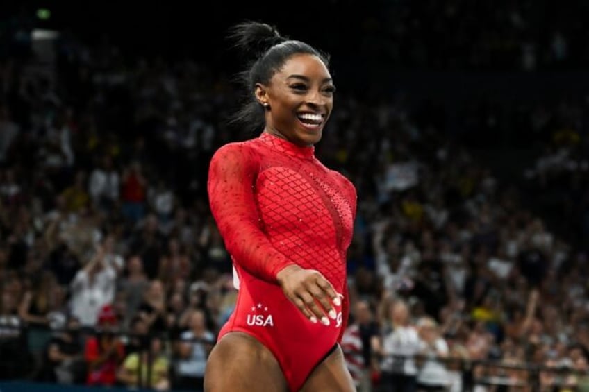 Simone Biles reacts after wrapping up women's gymnastics vault gold, her third gold medal