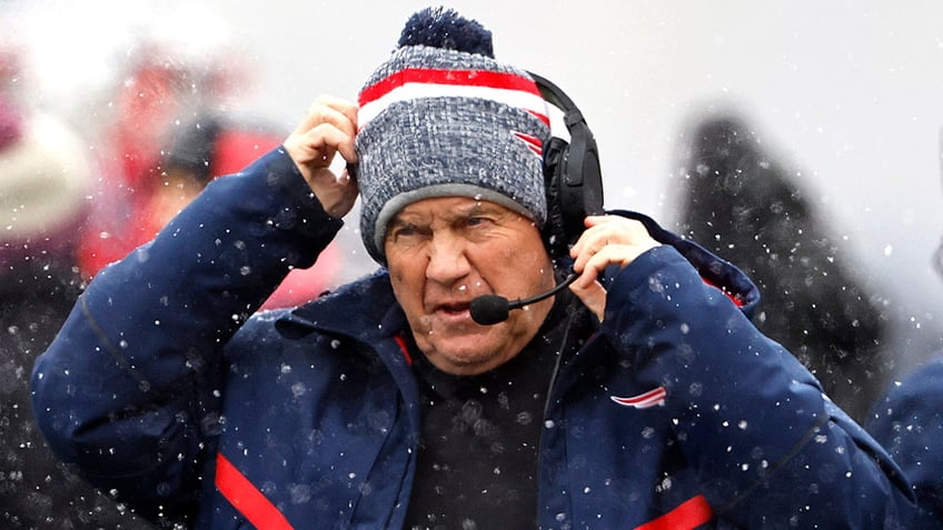 Bill Belichick adjusts his headset