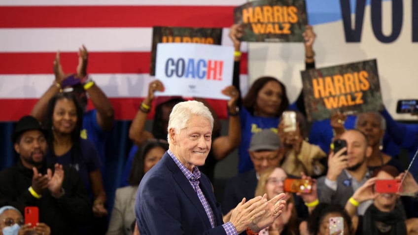 Bill Clinton with rally crowd behind him