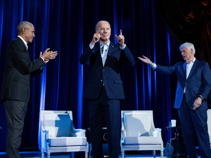 Former US President Barack Obama (L) and former US President Bill Clinton (R) cheer for US