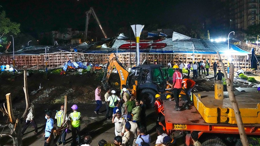 Rescuers, a collapsed billboard