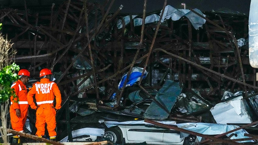 People at the scene of the billboard collapse