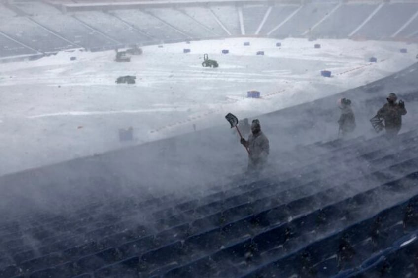 Workers remove snow from Highmark Stadium in Orchard Park, N.Y., Sunday Jan. 14, 2024. A potentially dangerous snowstorm that hit the Buffalo region on Saturday led the NFL to push back the Bills wild-card playoff game against the Pittsburgh Steelers from Sunday to Monday. New York Gov. Kathy Hochul and …