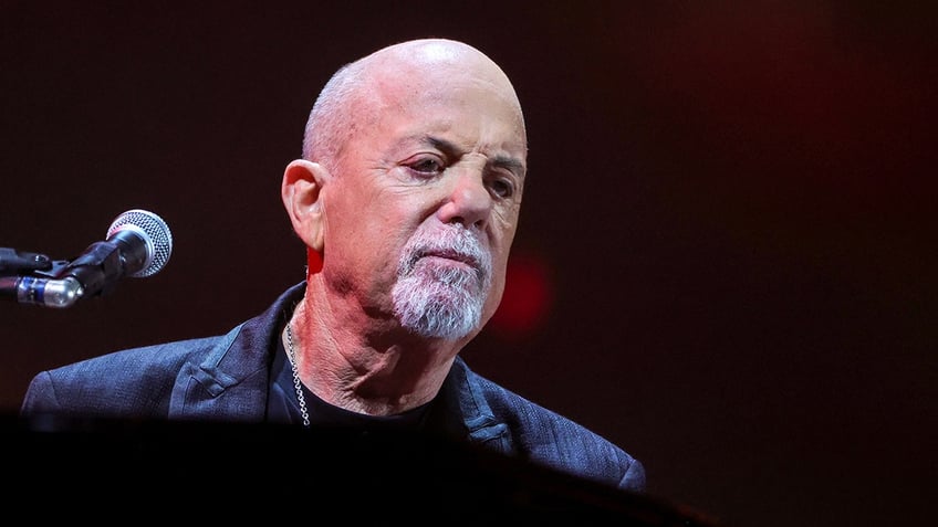 Close up of Billy Joel sitting behind piano