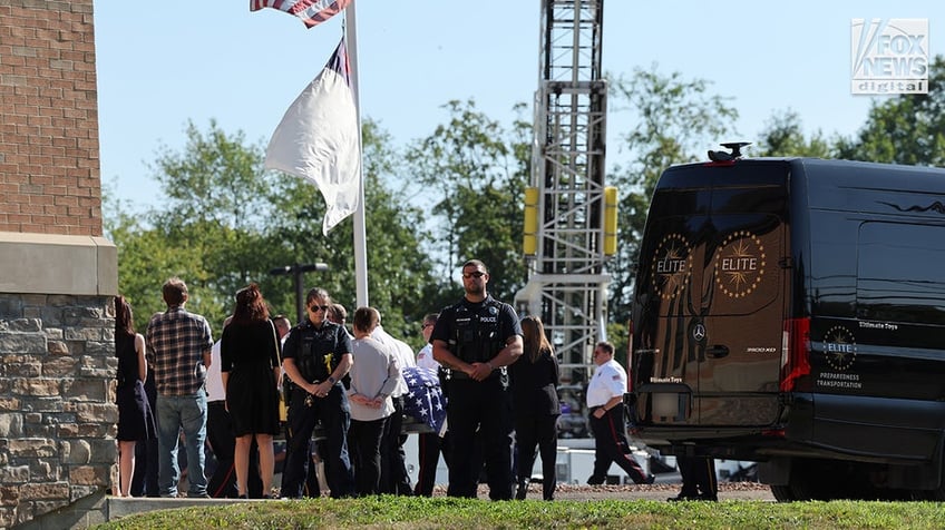 The casket of Corey Comperatore is carried into Cabot United Methodist Church