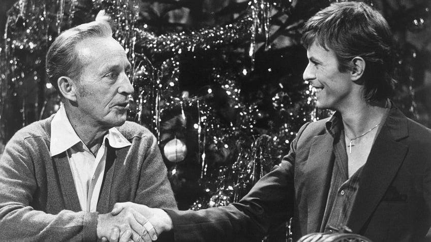 Bing Crosby shaking David Bowies hand