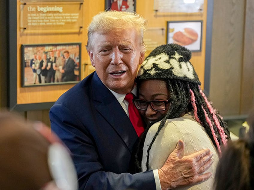 Republican presidential candidate former President Donald Trump, left, hugs a customer as