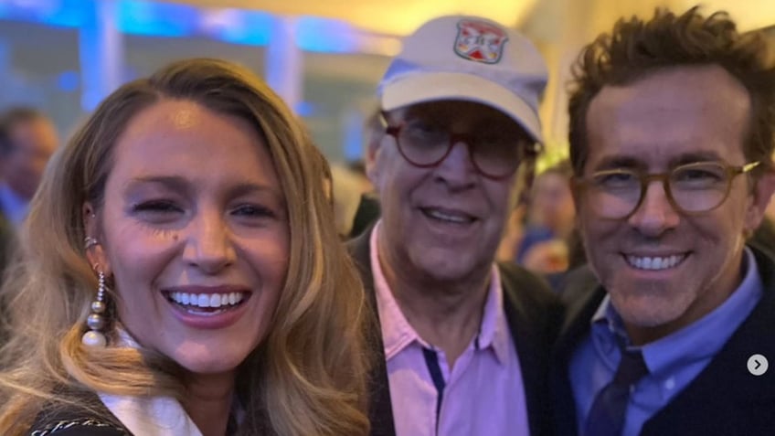 Blake Lively, Ryan Reynolds and Chevy Chase smile