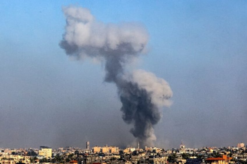 Smoke billows over Khan Yunis in the southern Gaza Strip during Israeli bombardment