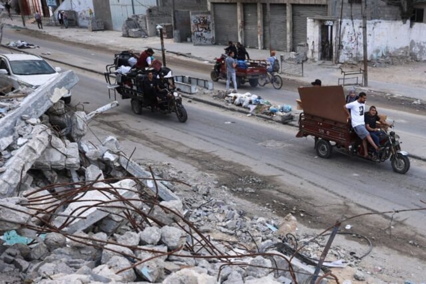 Palestinians transport their belongings as they flee Rafah in the southern Gaza Strip amid