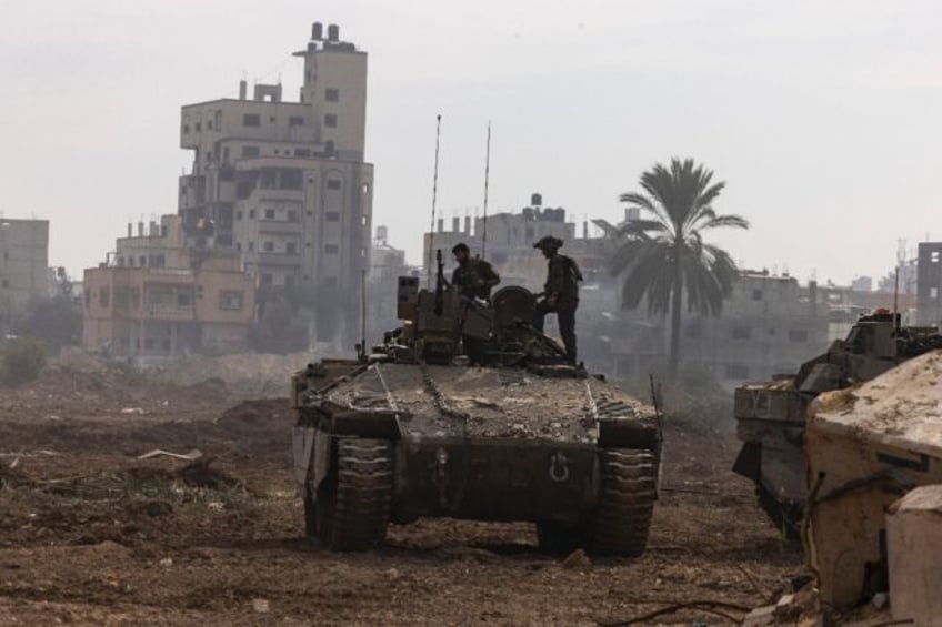 This picture, taken during a media tour organised by the Israeli military on January 8, 2024, shows troops operating in the central Gaza Strip, amid continuing battles between Israel and the Palestinian militant group Hamas