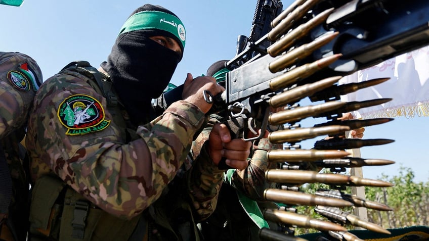 A Palestinian terrorist from the armed wing of Hamas takes part in a military parade