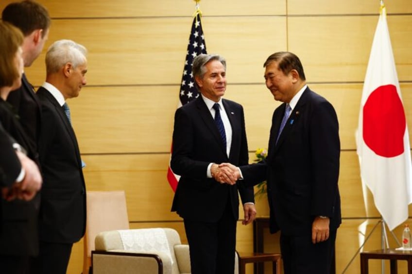 US Secretary of State Antony Blinken shakes hands with Japanese Prime Minister Shigeru Ish