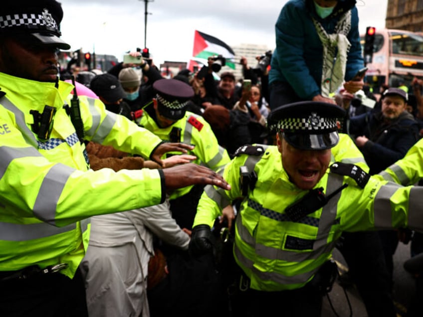 Metropolitan (MET) Police officers clash with protesters during a Pro-Palestinian demonstration in front of the Palace of Westminster, in central London, on January 6, 2024, calling for a ceasefire now in the war in Gaza. Thousands of civilians, both Palestinians and Israelis, have died since October 7, 2023, after Palestinian …