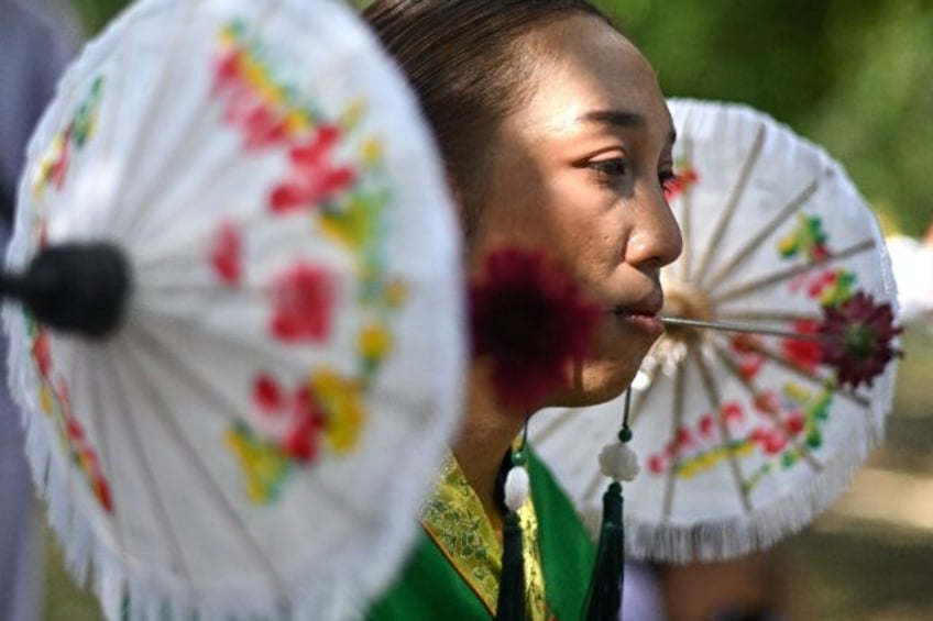 Devotees of the Jor Soo Gong Naka shrine in Thailand's Phuket pierce their faces during an